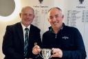 Falmouth Golf Club captain Phil Jones presents Paul Caunter with the John Rose Memorial Trophy