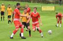 Porthleven striker Dan Quirke (centre) receives close attention from two Wadebridge men