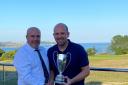 Peter Lewis (left)  Vice Captain of Falmouth Golf Club presenting the Bearne Cup to Mike Davies