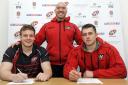 Matt Bolwell (left) and Marcus Garratt (right) put pen to paper on the deals with forwards coach Alan Paver overlooking them. Picture: SIMON BRYANT/ITKIS PHOTO