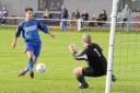 Darren Mageor marks his debut with a chip over the ‘keeper for his first Helston goal	Pictures: ALAN CHRISTOPHERS