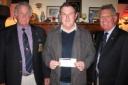 Organiser Lion John Buer and Lion President John Cardew present a cheque to Martyn Selley from Ella's Memory