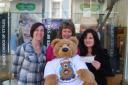 Penhaligon’s Friends charity workers collect their cheque from Redruth Specsavers.