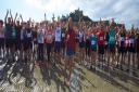 Penzance's Olympic gold medalist Helen Glover and the beach runners
