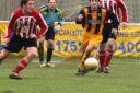 IN PURSUIT: Town's Aaron Cusack is outnumbered as he tries to win possession