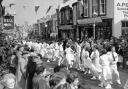 n An old photograph of the Children’s Dance heading along Meneage Street