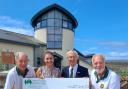Mawnan Bowling Club Chairman Alf Rodda presents Amanda Masters with a cheque, flanked by Chris Crouch, left and Dave Kirk, right.
