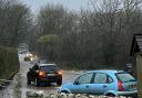 Cars stuck in flooded road near Music Water Touring Park
