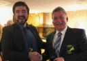 Ed Oxford presents Mullion Golf Club captain Wilf Hutchinson with the coveted Coverack Masters green jacket