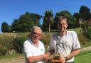Chris Mason (right) is presented with the David Sadler Trophy by Budock Vean Club Secretary Dennis McQuillan
