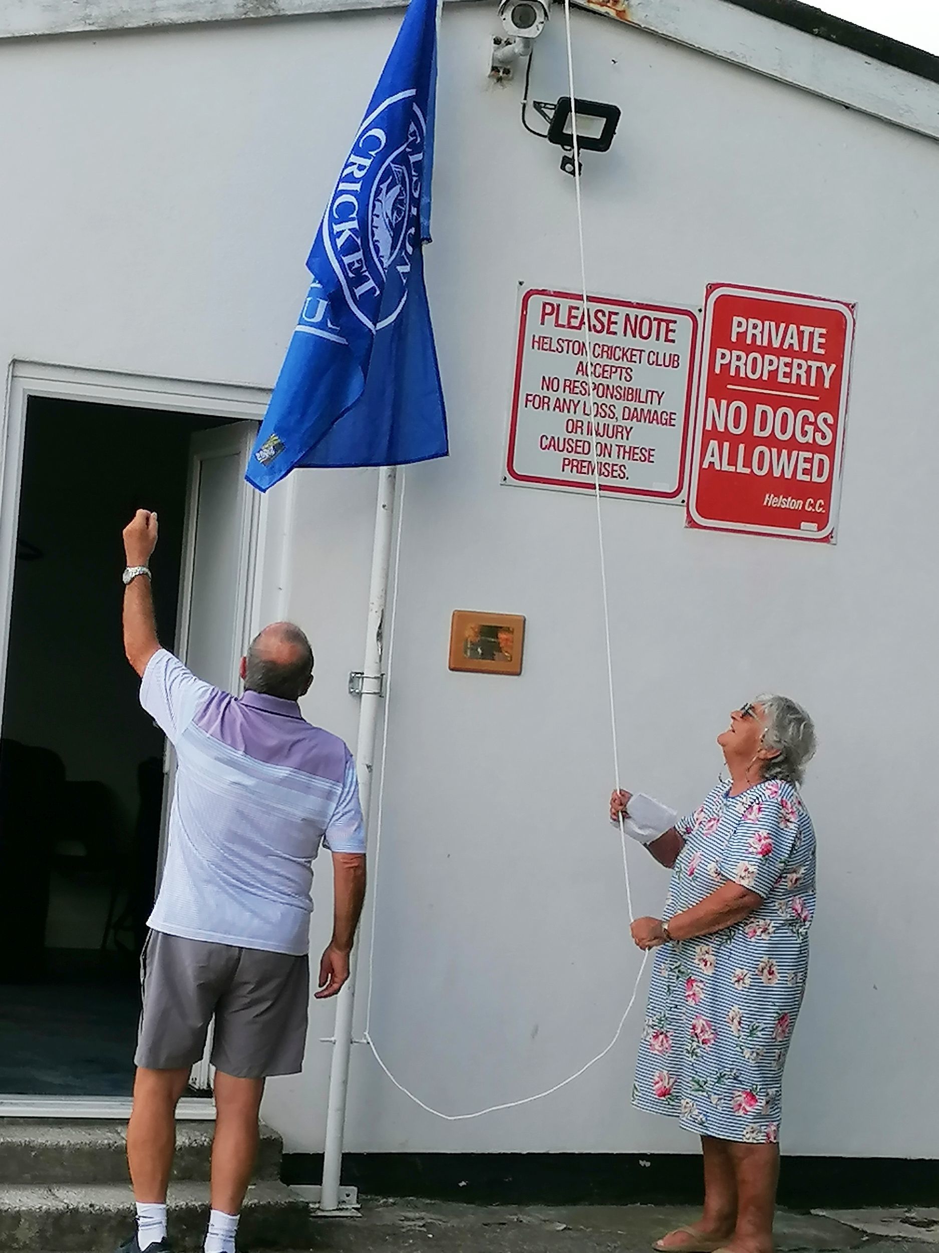 Deirdre and Peter flying the new flag above the clubhouse for the first time