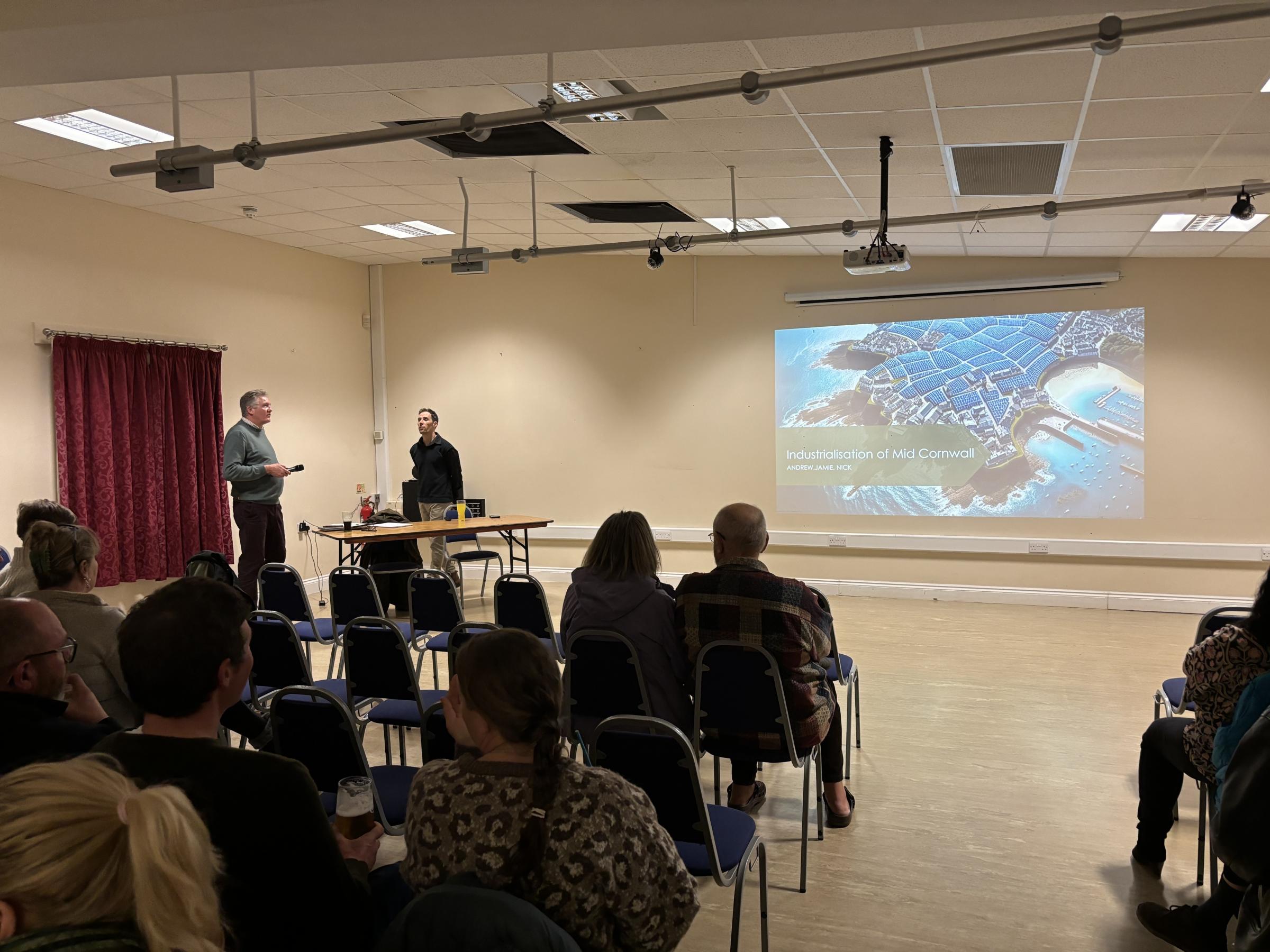 Andrew Stanners, left, and Jamie Crossman prepare to present a talk about the \Industrialisation of Mid Cornwall\ at the solar farms public meeting in St Erme (Pic: Lee Trewhela / LDRS)