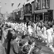 n An old photograph of the Children’s Dance heading along Meneage Street