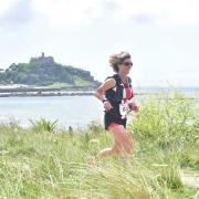 A participant running past St Micheals Mount.
