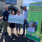 Brian Fisher and Martin Mills handing over the cheque to Children’s Hospice South west at Little Harbour