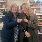 Sandy Skinner hands over the keys to Laura Smythe at Flushing Stores