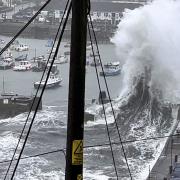 A spectacular shot of a wave exploding in Porthleven harbour