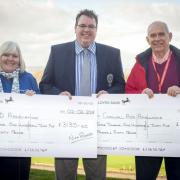 Nick Rogers presents cheques to the Cornwall Air Ambulance and the Motor Neurone Association