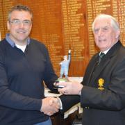 Steve Jones (left) receiving the Winter League Trophy form Falmouth Golf Club Captain William McLean.
