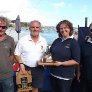 Tim Bailey (left) and Neil Andrew receive the championship trophy and prizes from Sarah and Simon Treen.