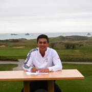 George Leigh signs his scholarship papers at his home course of Trevose