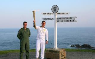 Ben Ainslie with the torch. Picture by Jon Crwys-Williams