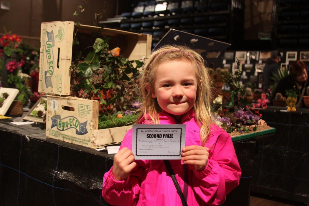Matilda, 6, from Marlborough School, next to the school's Secret Garden display