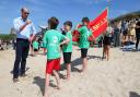William speaks with members of Holywell Bay Surf Life Saving Club during a visit to Fistral Beach in Newquay