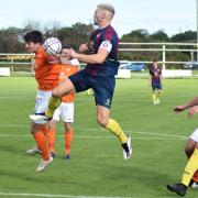 Scott Palmer (centre) goes for a header during Saturday's defeat