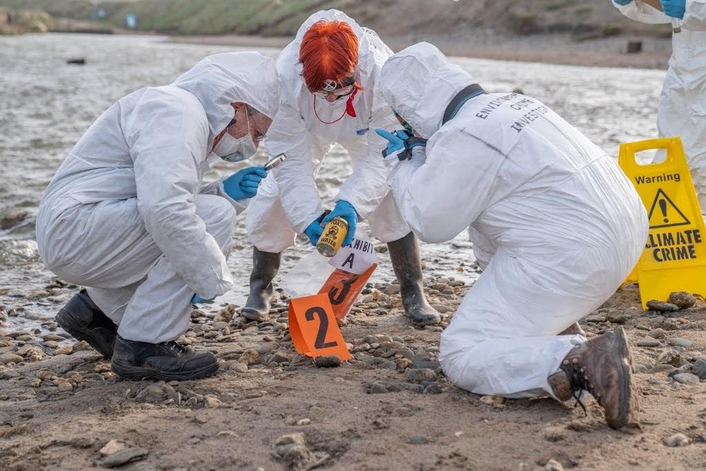 Climate activist 'Crime Scene Investigators' highlight 'toxic' rivers in Cornwall.  Extinction Rebellion taking samples at the Red River, Gwithian yesterday