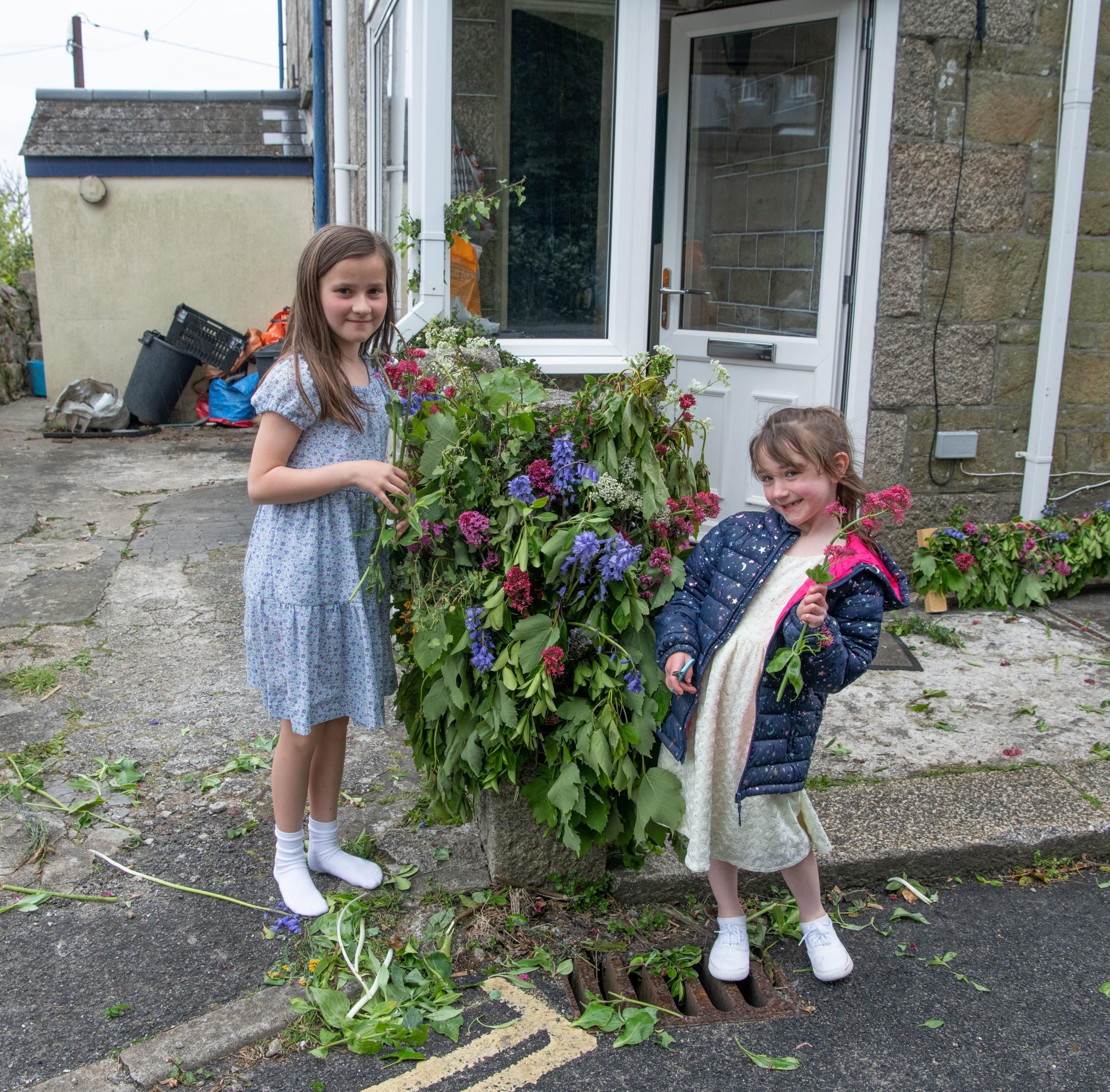 Caitlin and Hetty decorating for Flora Day still. Picture: Kathy White