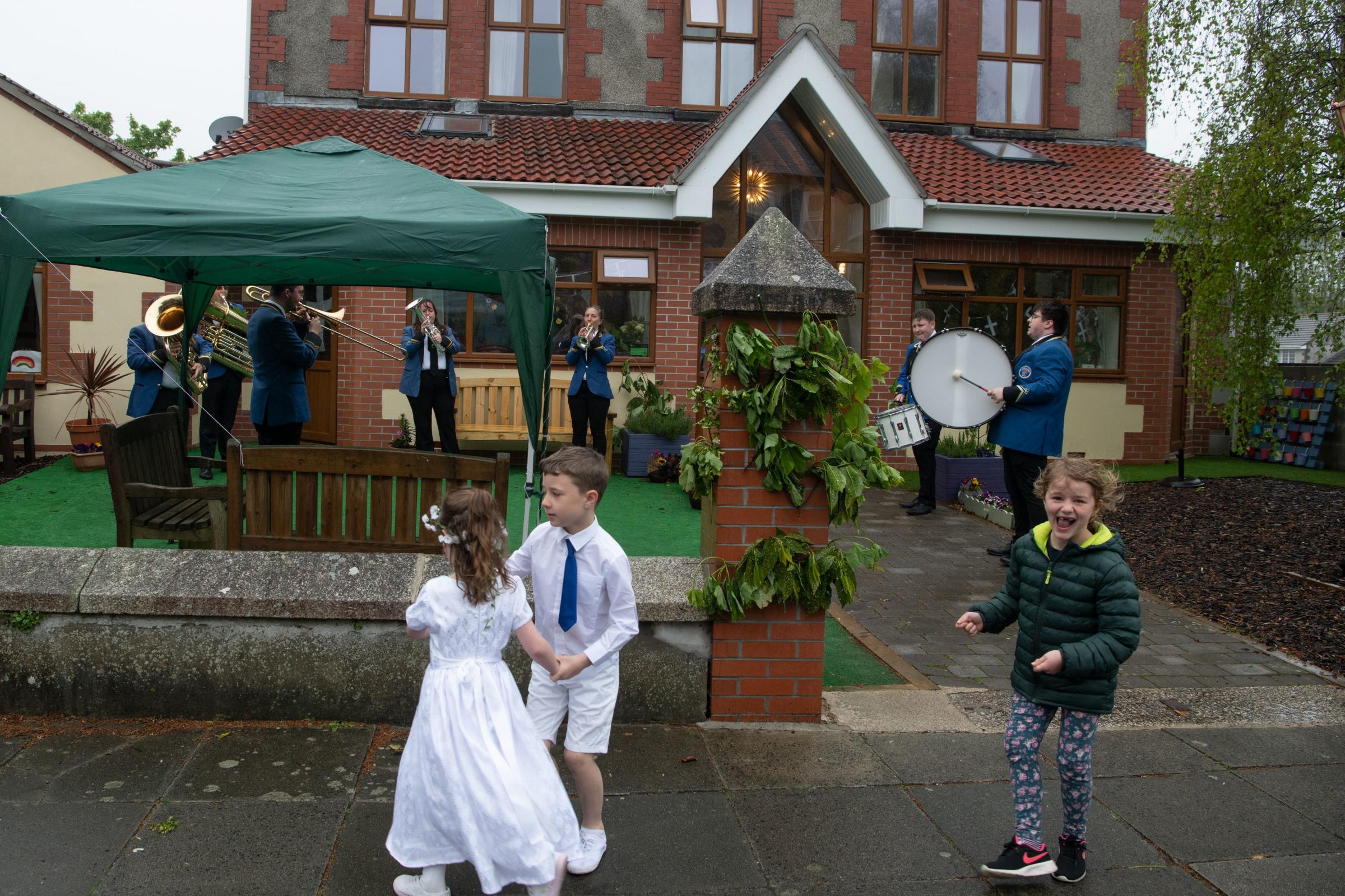 Neighbouring children dance past Godolphin House as the band plays. Picture: Kathy White