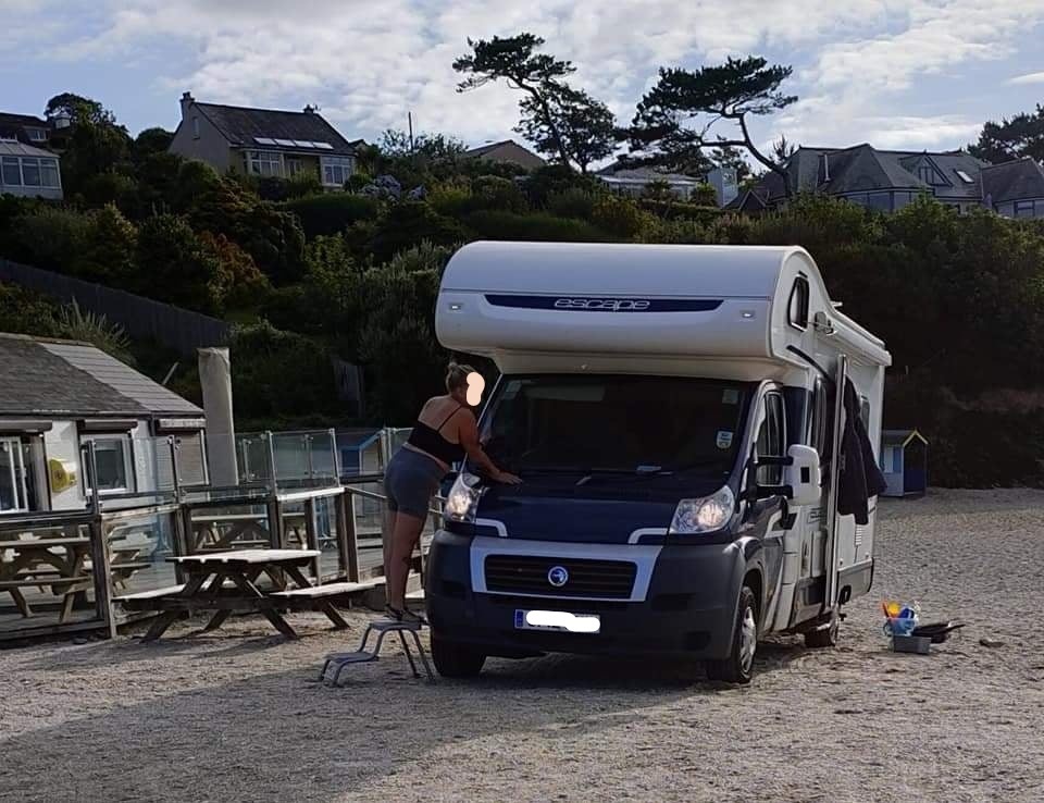 The van was parked on the beach in front of Swanpool Cafe
