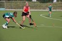 Laura Heather passes a ball past a Newquay player Lora Millward