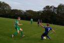 Perranwell Reserves attempt to clear as Mawnan Reserves’ Seb Hennessy closes in their St Piran League division two clash