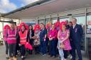Staff and guests celebrate wear it pink day as part of the ribbon cutting