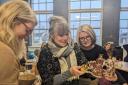 Jane Sutherland (centre) admires a gift from Creative Kernow colleagues and collaborators