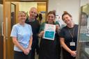Louise holding her certificate, with colleagues from the Proper Job project