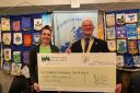 Amanda Masters, from Children's Hospice South West, is presented a cheque by Helston Rotary club president John Notley