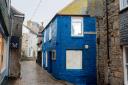 There is uproar over a building in one of St Ives' historic streets being painted dark blue