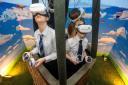 Students try out the virtual reality balloon ride along the Mid Cornwall Metro route