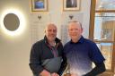 Falmouth Golf Club captain Pete Lewis (left) presenting the Winter league trophy to Mike Elliott