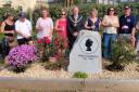 Porthleven mayor Cllr Michael Toy unveils the memorial dedicated to the Queen along with deputy mayor Emma Louise Short and members of the community