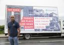 CEO Sanj Srikanthan poses with a van featuring a provocative billboard launching the ShelterBox ‘Human habitat loss’ campaign, which urges leaders ahead of arriving in Cornwall for the G7 Summit to find global solutions to the climate crisis,