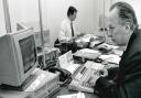 John Reynolds at work in the County Press newsroom in the early 1990s, with colleague George Chastney in the background.
