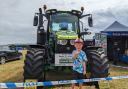 Four-year-old Reuben Mudge gives a thumbs up in front of Optimus Crime