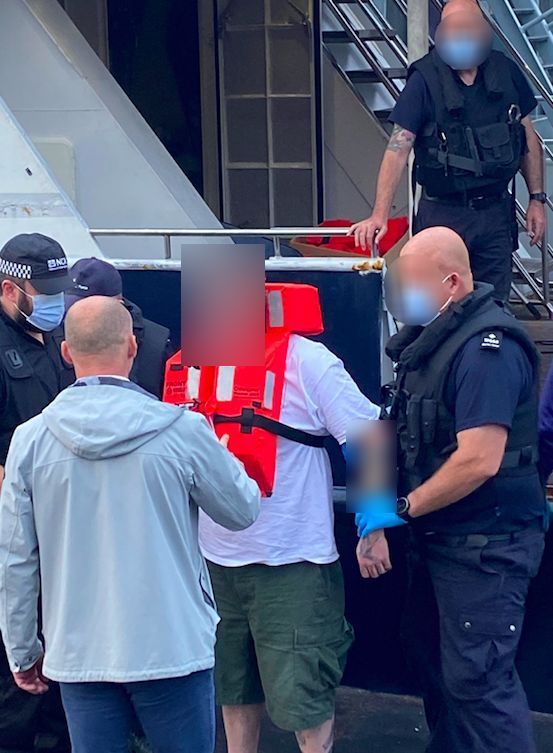 A suspect is arrested from the yacht Picture: National Crime Agency