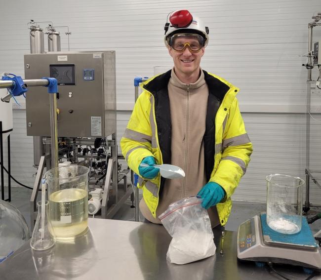 Chemistry specialist Aaron Taylor with a sample of the first high purity lithium carbonate to be produced in British Lithium’s new state of the art pilot plant