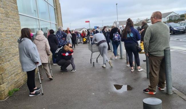 Customers lined up outside the Helston Tesco store after it was evacuated on Tuesday lunchtime