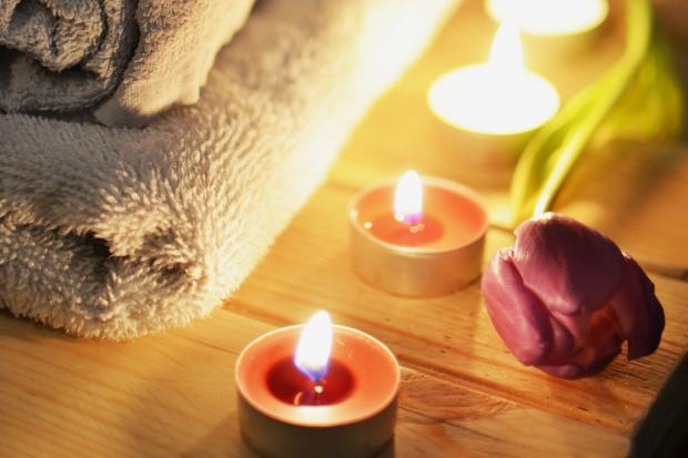Falmouth Packet: A pile of towels, candles and a tulip. Credit: Canva